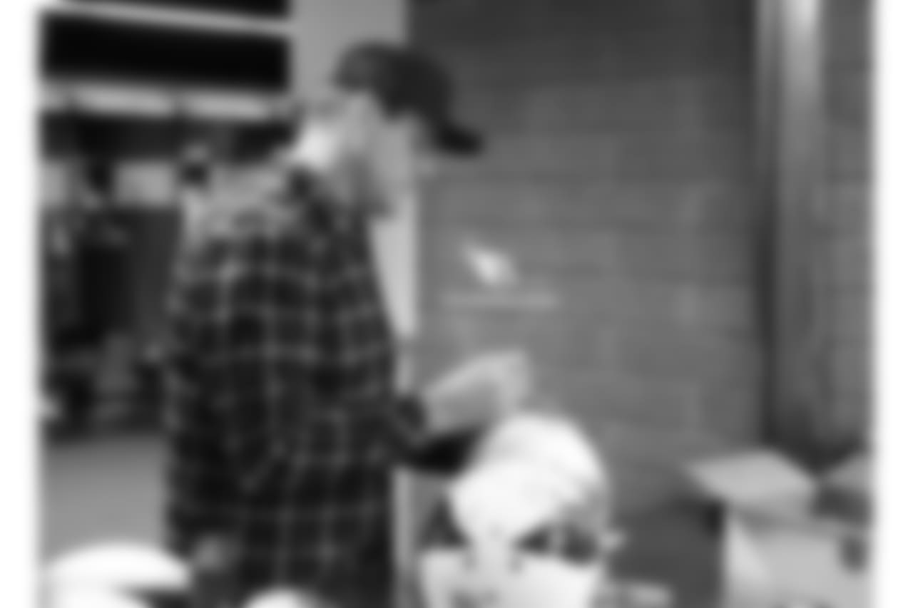 Palmer signs a helmet on locker cleanout day at the end of the 2017 season