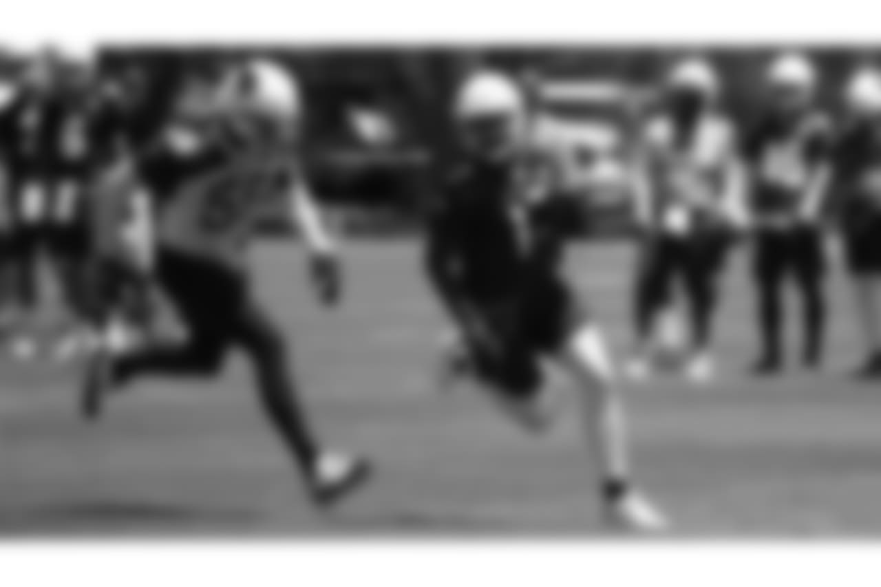 WR Jalen Tolliver (right) runs away from LB Edmond Robinson