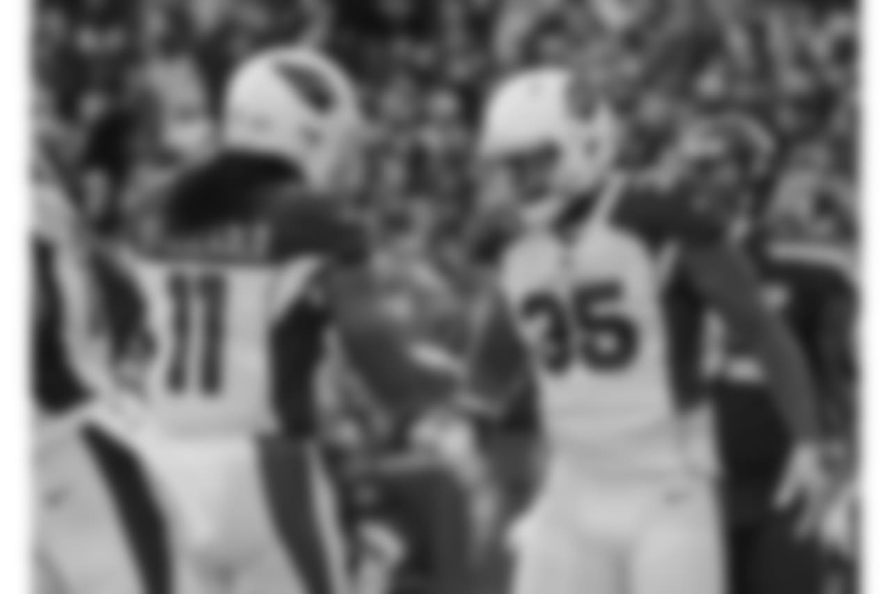 Larry Fitzgerald (left) congratulates RB Elijhaa Penny (right) after punching in a touchdown