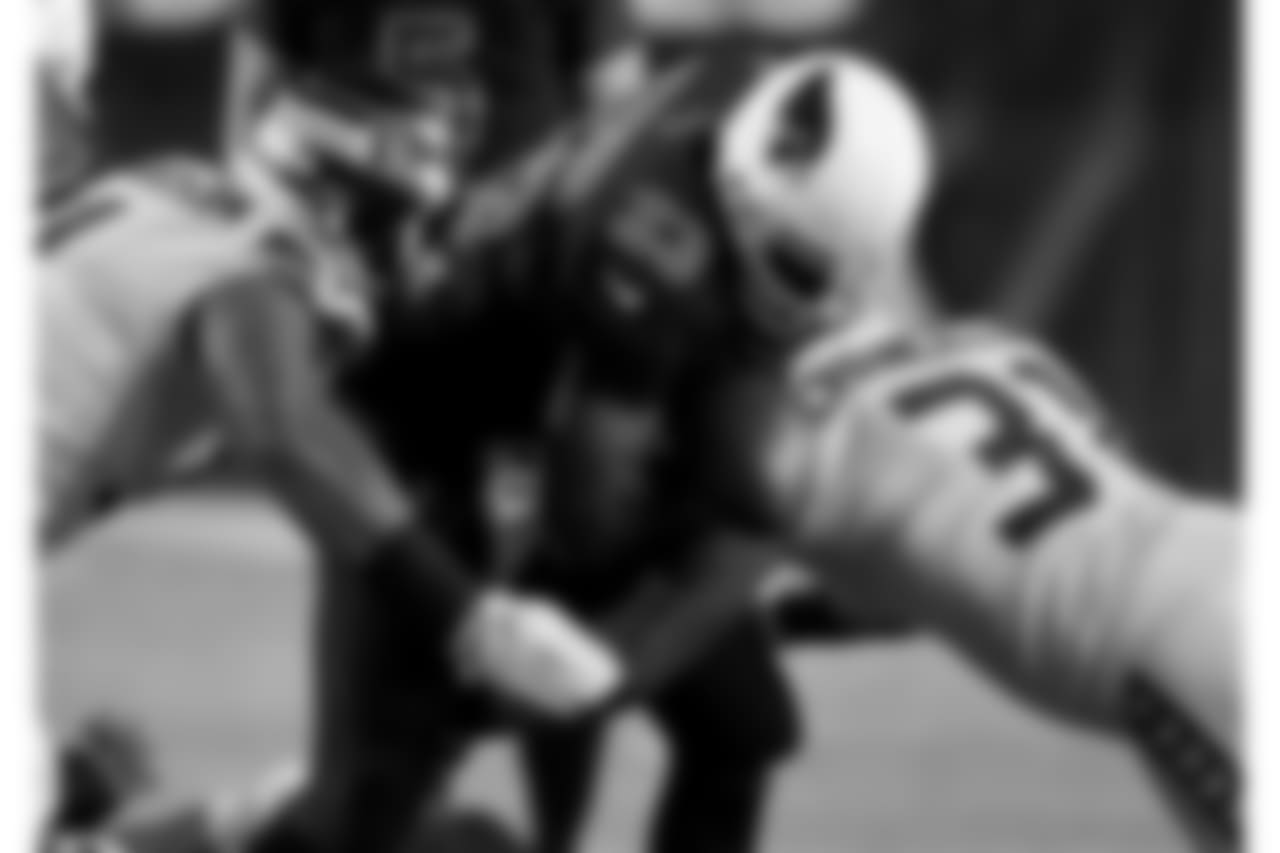 Seahawks S Kam Chancellor knocks the ball loose from Cardinals RB Adrian Peterson