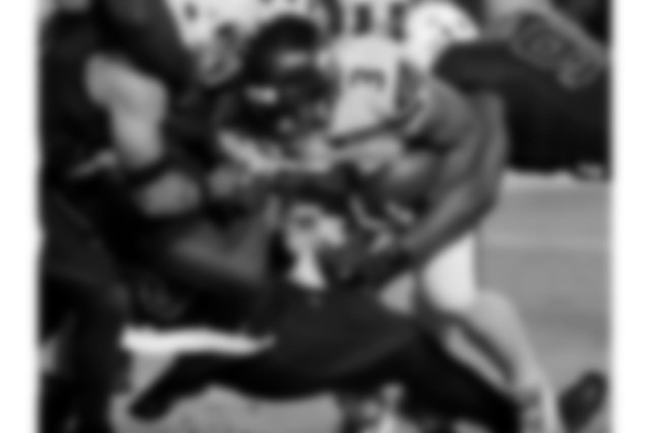 Seahawks QB Russell Wilson plows through the Cardinals' defense