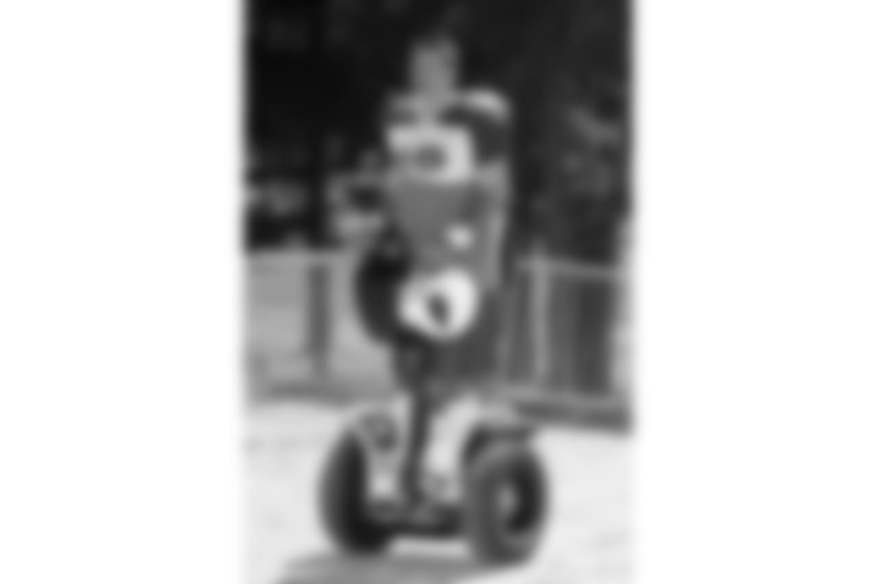 Warner rides a Segway in training camp