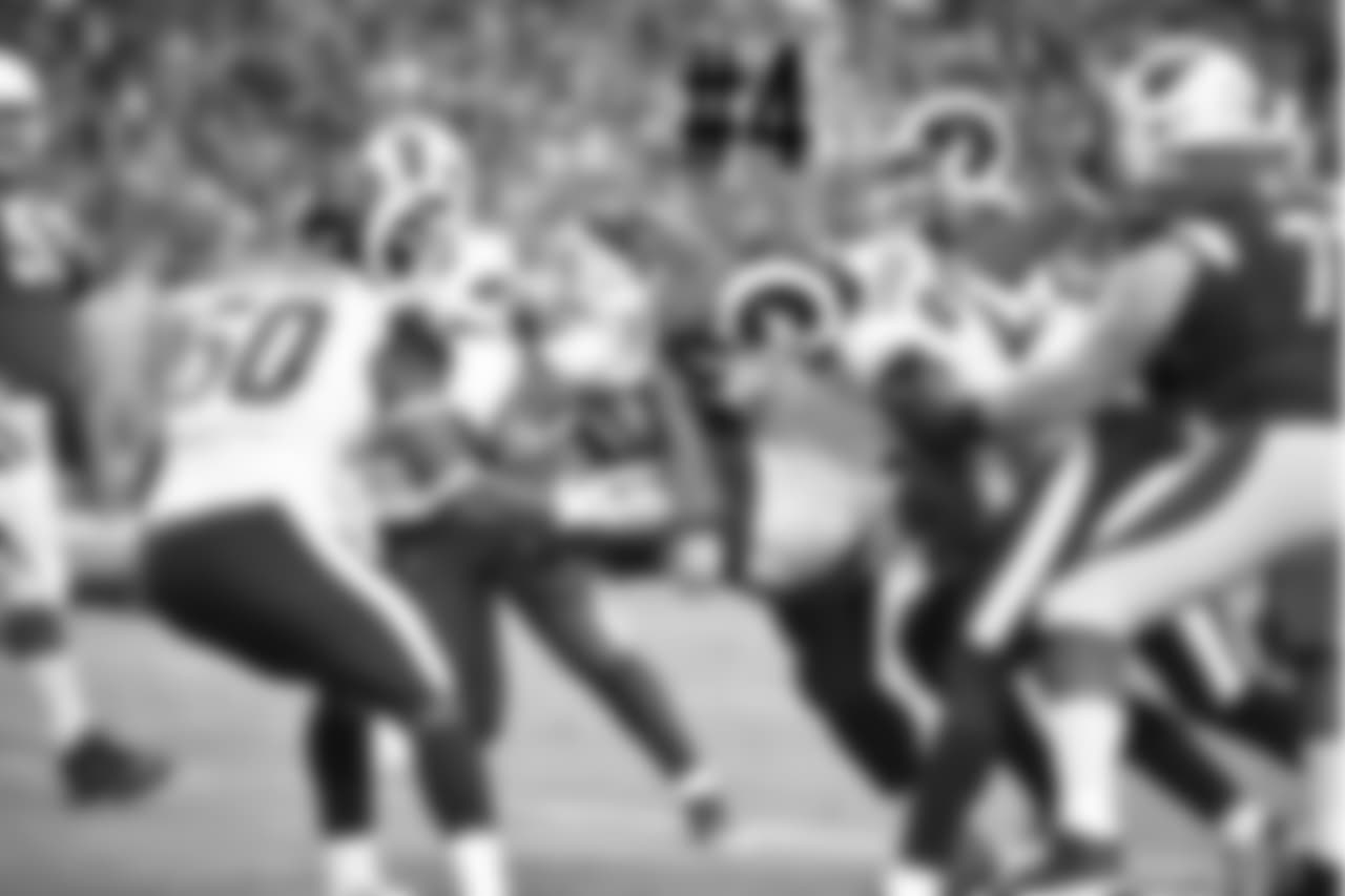WR Larry Fitzgerald is grabbed by multiple Rams defenders