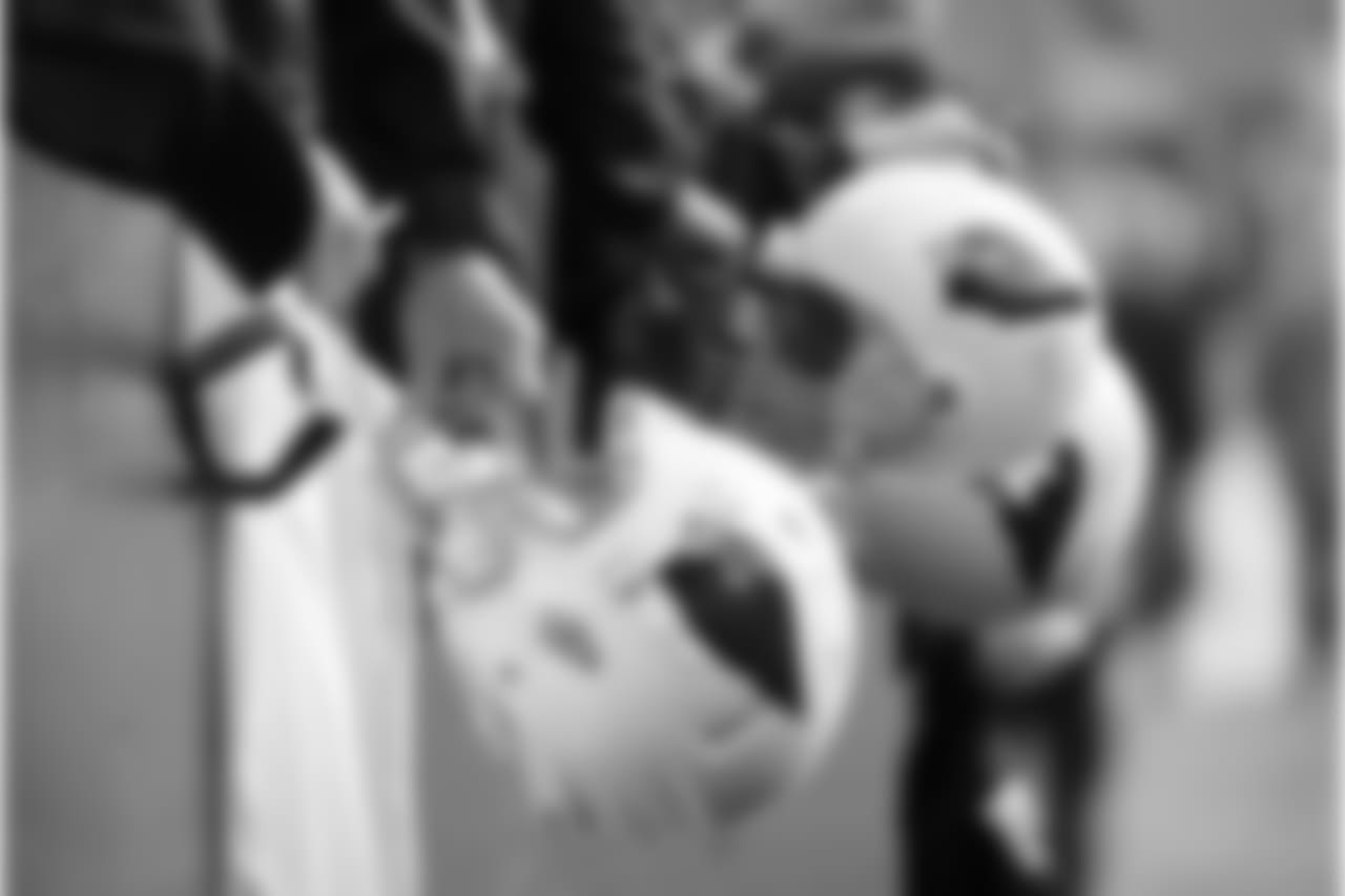 Cardinals fans hold helmets before the game
