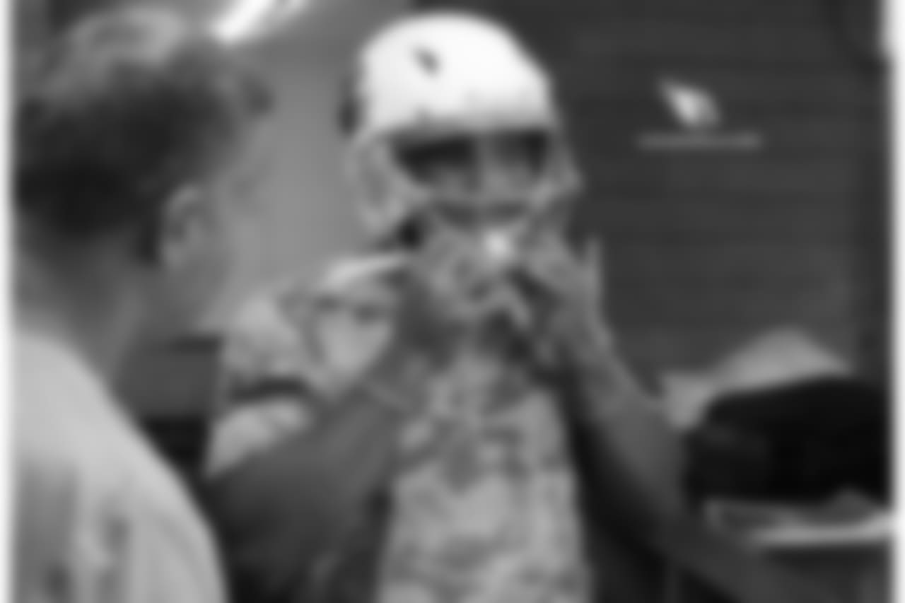 WR Christian Kirk tries on his helmet