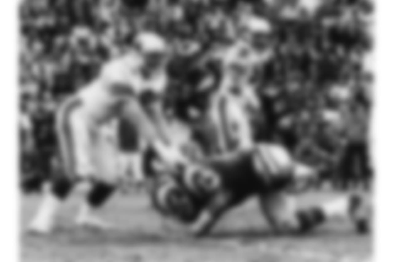 1975: G Conrad Dobler blocks Rams DT Merlin Olsen