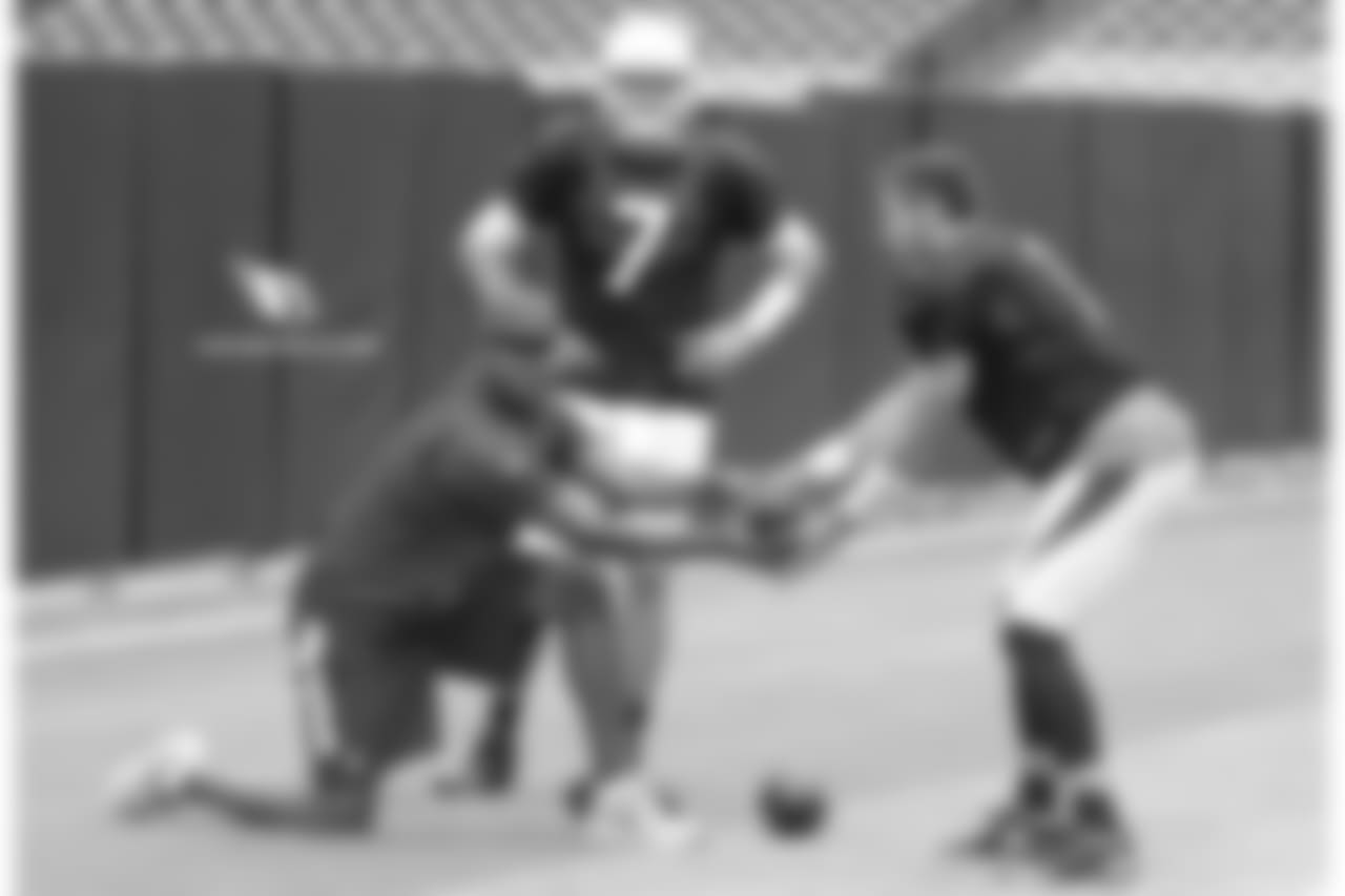 QB coach Byron Leftwich snaps the ball to QB Trevor Knight