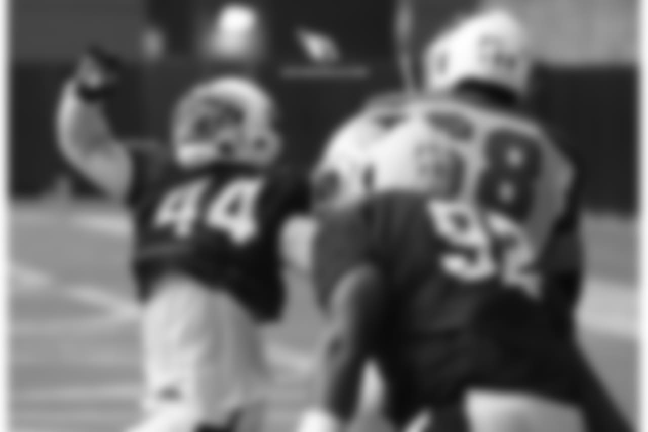 LB Markus Golden (left) goes against T Jared Veldheer in a pass-rush drill