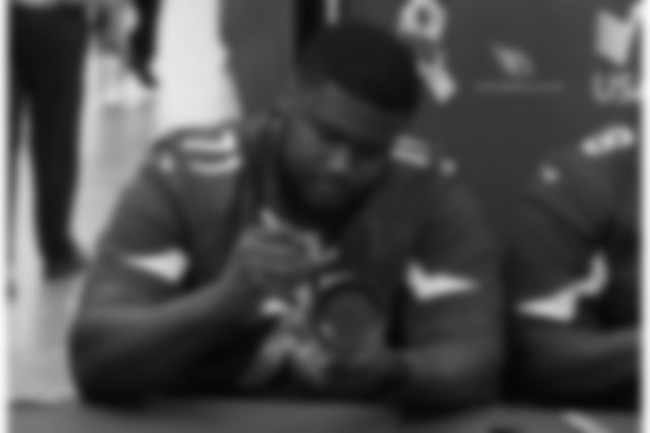 G Kaleb Johnson signs an autograph