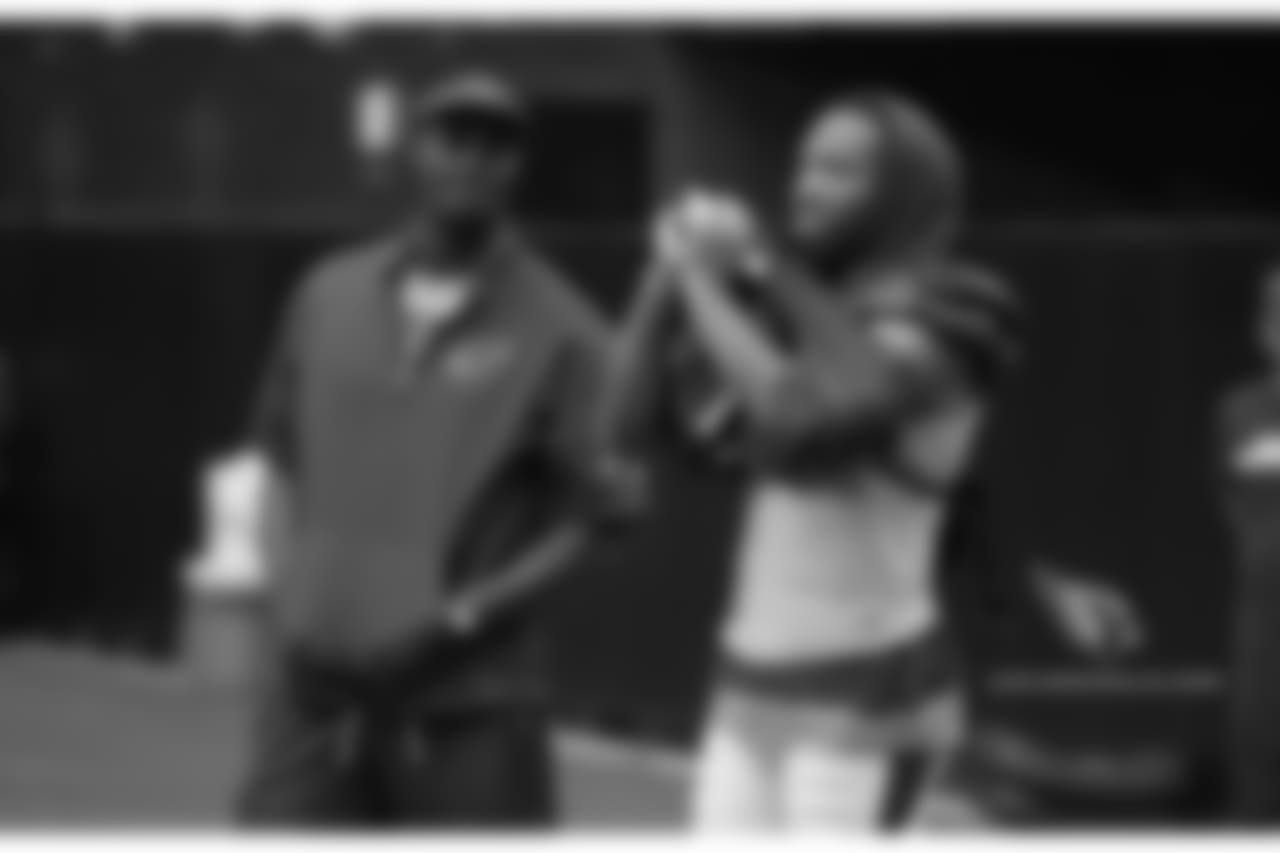 Coaching intern Plaxico Burress and WR Larry Fitzgerald