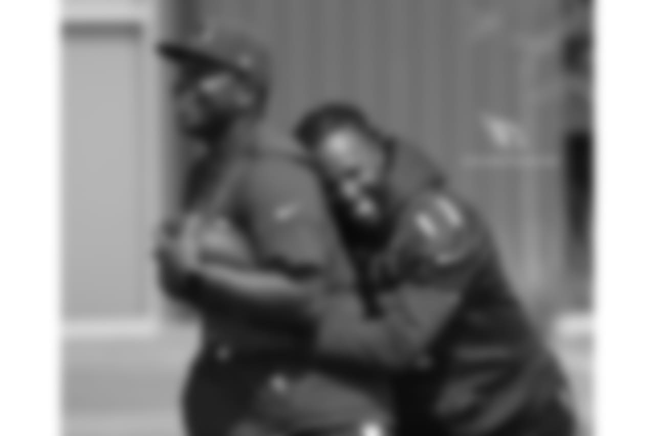 WR Larry Fitzgerald hugs QB coach Byron Leftwich