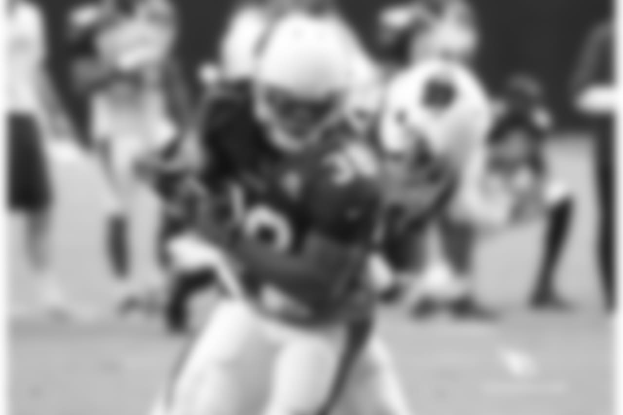 RB Andre Ellington is wrapped up by S Harlan Miller