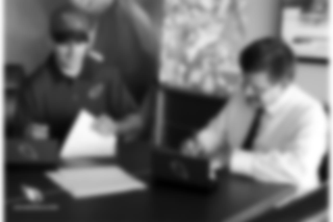 QB Josh Rosen looks over his rookie contract with team president Michael Bidwill