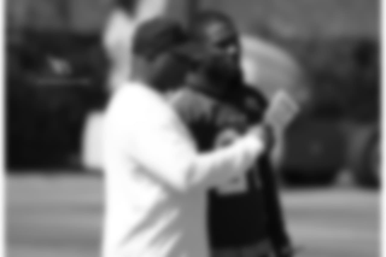 Cornerbacks coach Kevin Ross (left) talks with CB Patrick Peterson