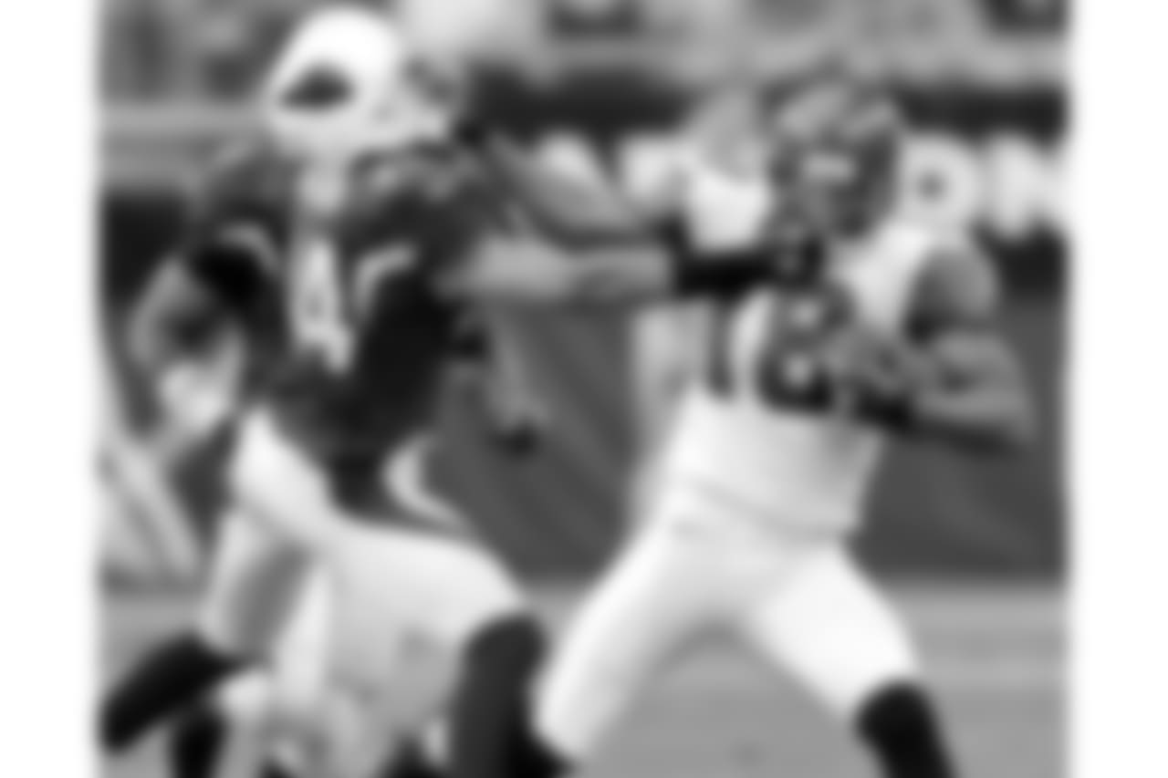 2006: The Cardinals' Robert Griffith and Seattle's D.J. Hackett grasp each other's facemask