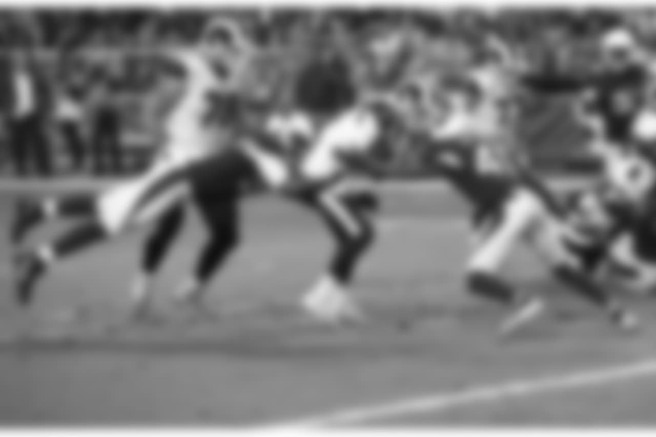 Rams QB Jared Goff pressured by Cardinals LB Karlos Dansby (left) and S Antoine Bethea (right)