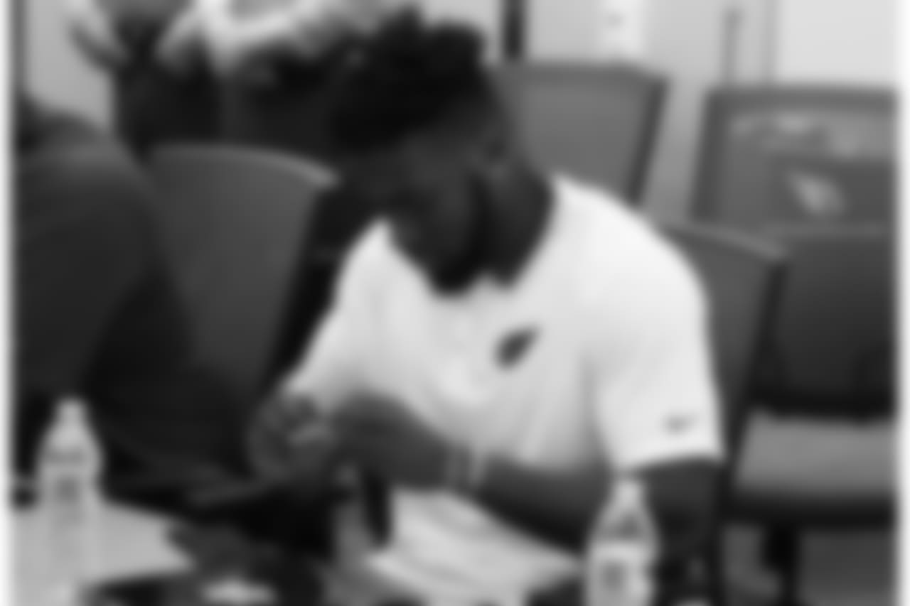 RB T.J. Logan checks out a patch given to him by the sheriff's office