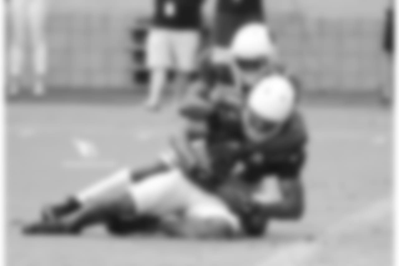 WR Larry Fitzgerald gets tackled by CB Brandon Williams