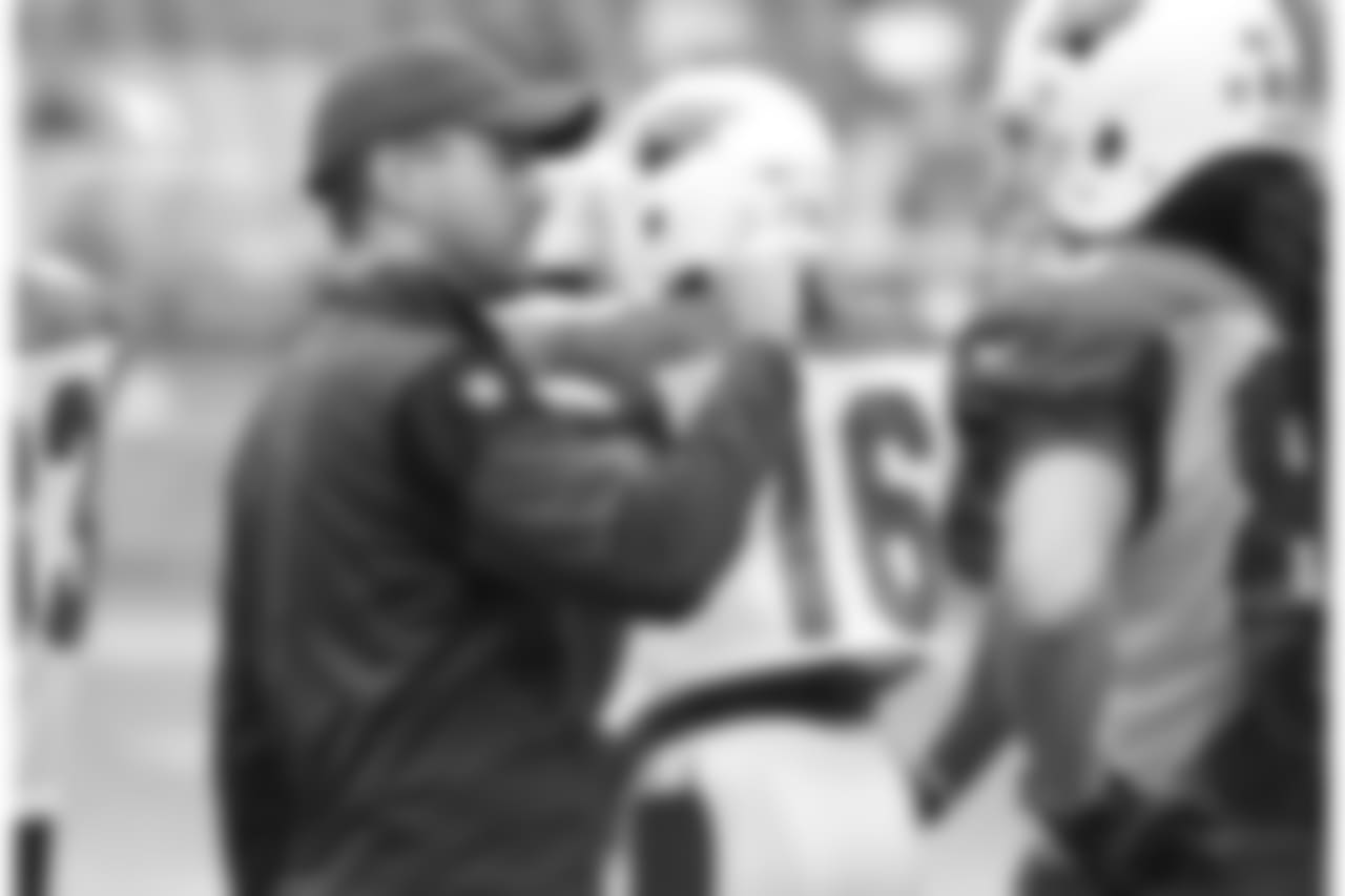 Assistant WR coach Kevin Garver explains something to WR Krishawn Hogan