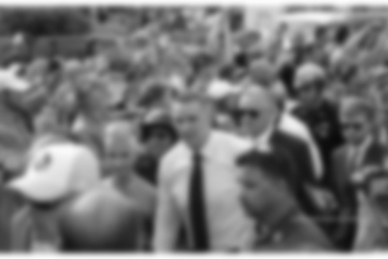 Kurt and Brenda Warner are escorted through the crowd