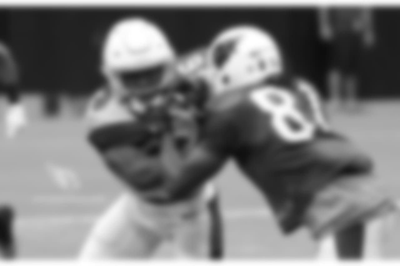 S Budda Baker tries to shed the block of WR Chris Hubert