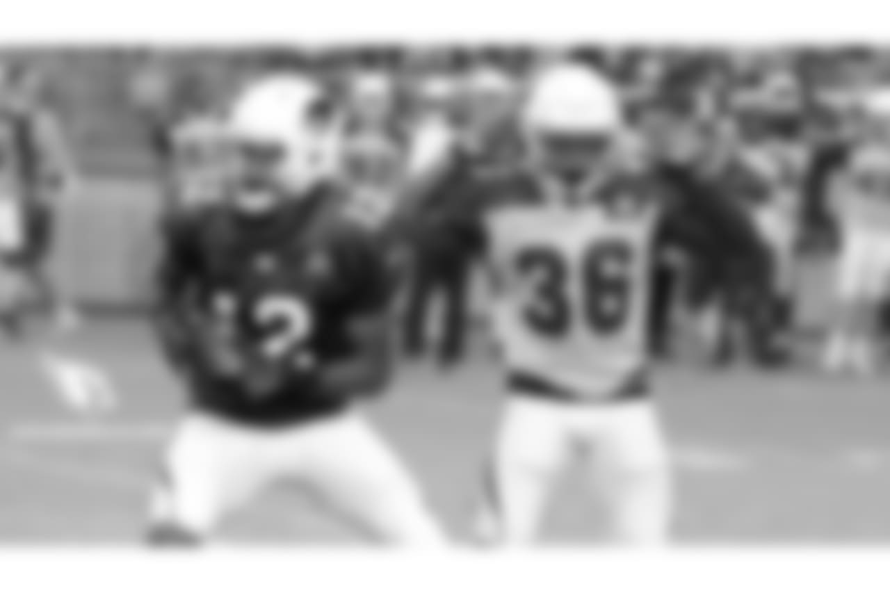 S Budda Baker (right) keeps his hands off WR Brice Butler