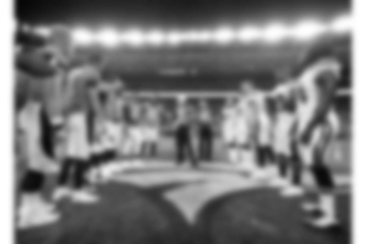 The Denver Broncos and the Los Angeles Chargers stand at mid field for the coin toss prior to an NFL football game, Monday, Sept. 11, 2017, in Denver. (AP Photo/Jack Dempsey)