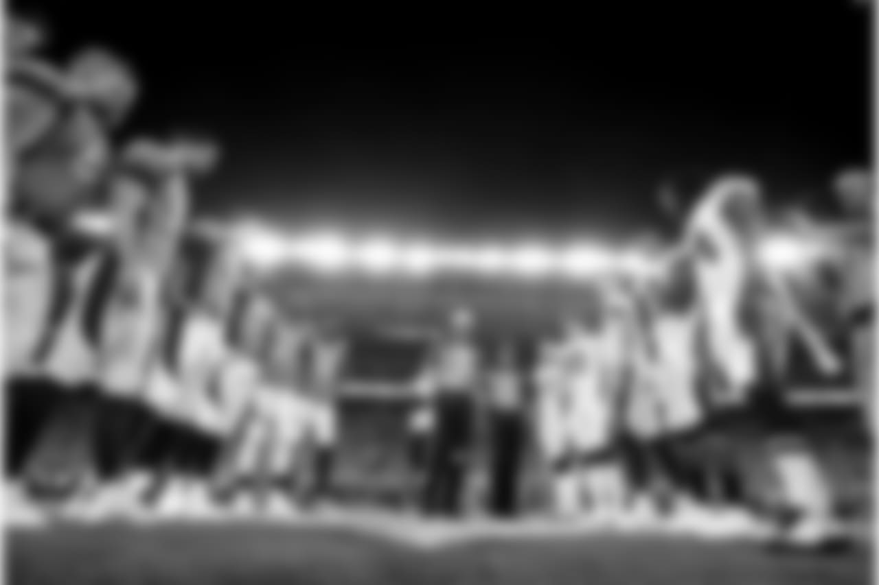 The Denver Broncos and the Los Angeles Chargers stand at mid field for the coin toss prior to an NFL football game, Monday, Sept. 11, 2017, in Denver. (AP Photo/Jack Dempsey)