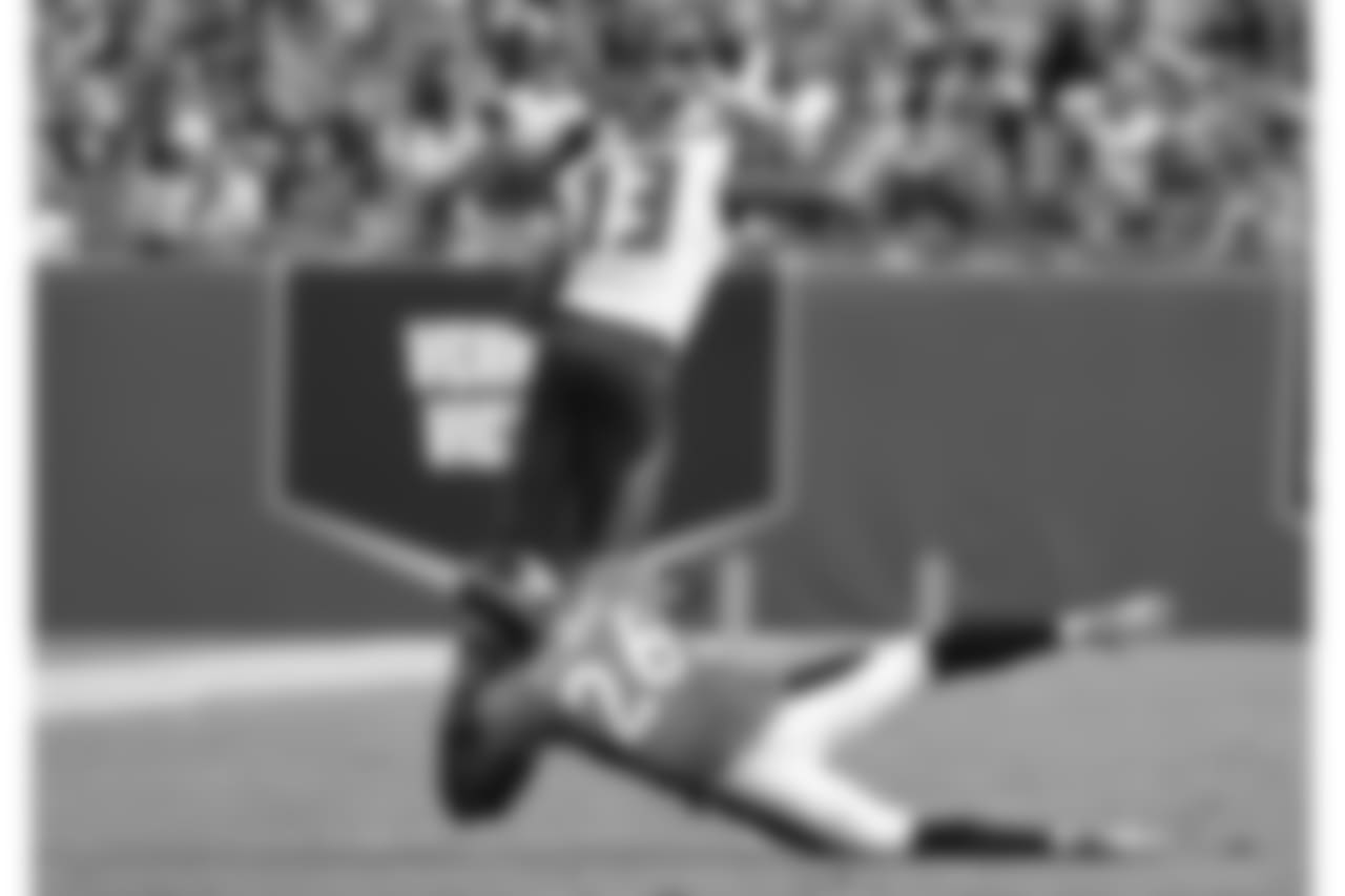 Tampa Bay Buccaneers wide receiver Mike Evans (13) dives from Denver Broncos safety Darian Stewart (26) for a gain in a week four NFL football game in Tampa, Fla. Denver won 27 - 7. (Al Messerschmidt via AP)