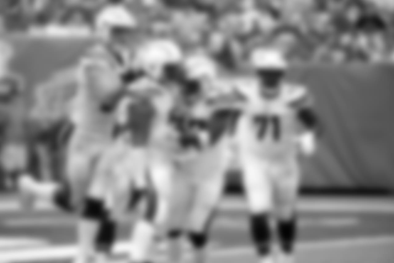Los Angeles Chargers players celebrate a sack by defensive end Darius Philon (93) during the second half of an NFL football game against the New York Giants, Sunday, Oct. 8, 2017, in East Rutherford, N.J. (AP Photo/Seth Wenig)