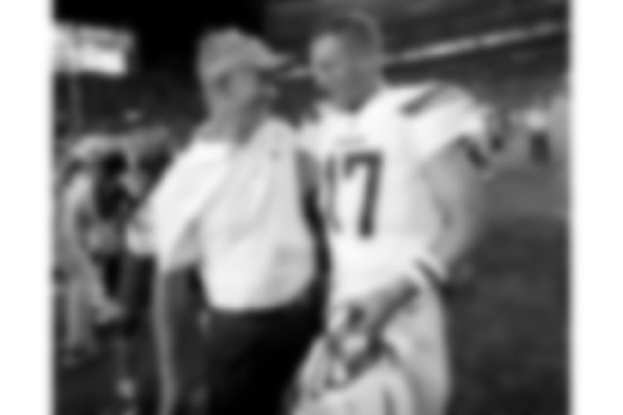 Los Angeles Chargers quarterback Philip Rivers (17) greets Denver Broncos offensive coordinator Mike McCoy after an NFL football game, Monday, Sept. 11, 2017, in Denver. The Broncos won 24-21. (AP Photo/David Zalubowski)