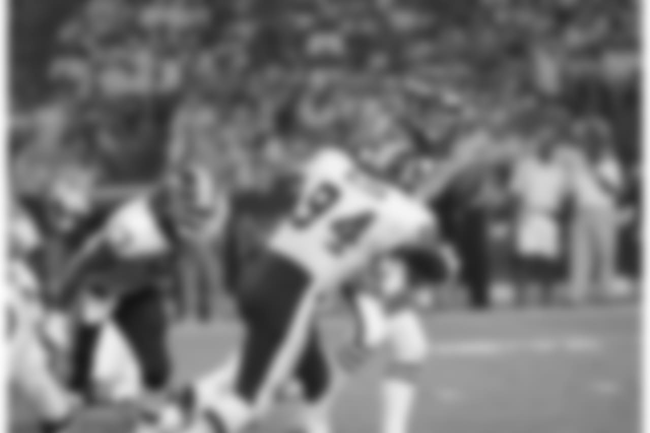 Washington Redskins defensive tackle Bobby Wilson (94) sacks New York Jets quarterback Boomer Esiason (7) for a loss during the second quarter in WashingtonÂ’s RFK Stadium, Aug. 27, 1993. The Redskins defeated the Jets 17-3. (AP Photo/Mark Wilson)