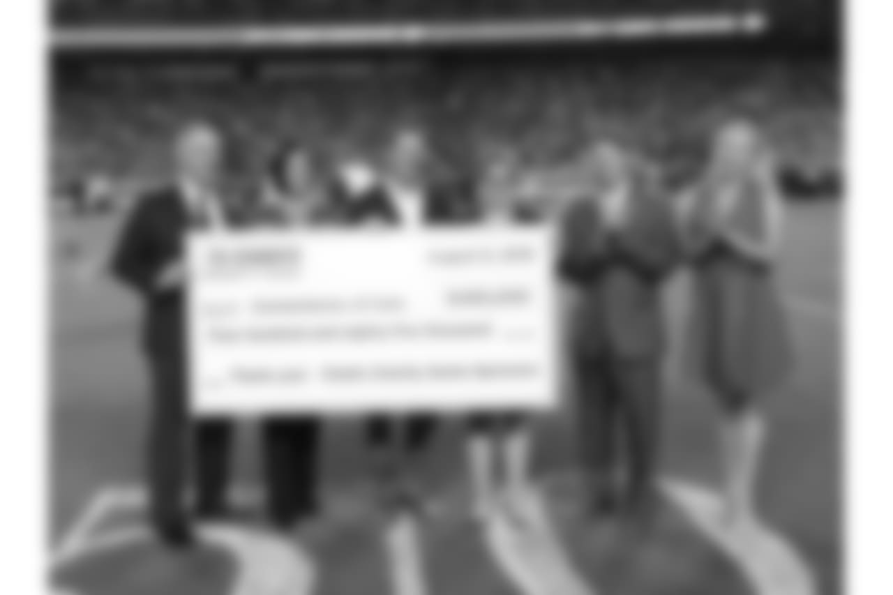 Clark Hunt presents a check to Cornerstones of Care during Texans at Chiefs at Arrowhead Stadium on 8/9/18.