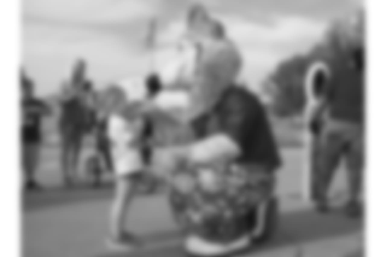KC Wolf and a young fan on 8/4/18 at Chiefs Training Camp at Missouri Western State University in St. Joseph, Missouri.