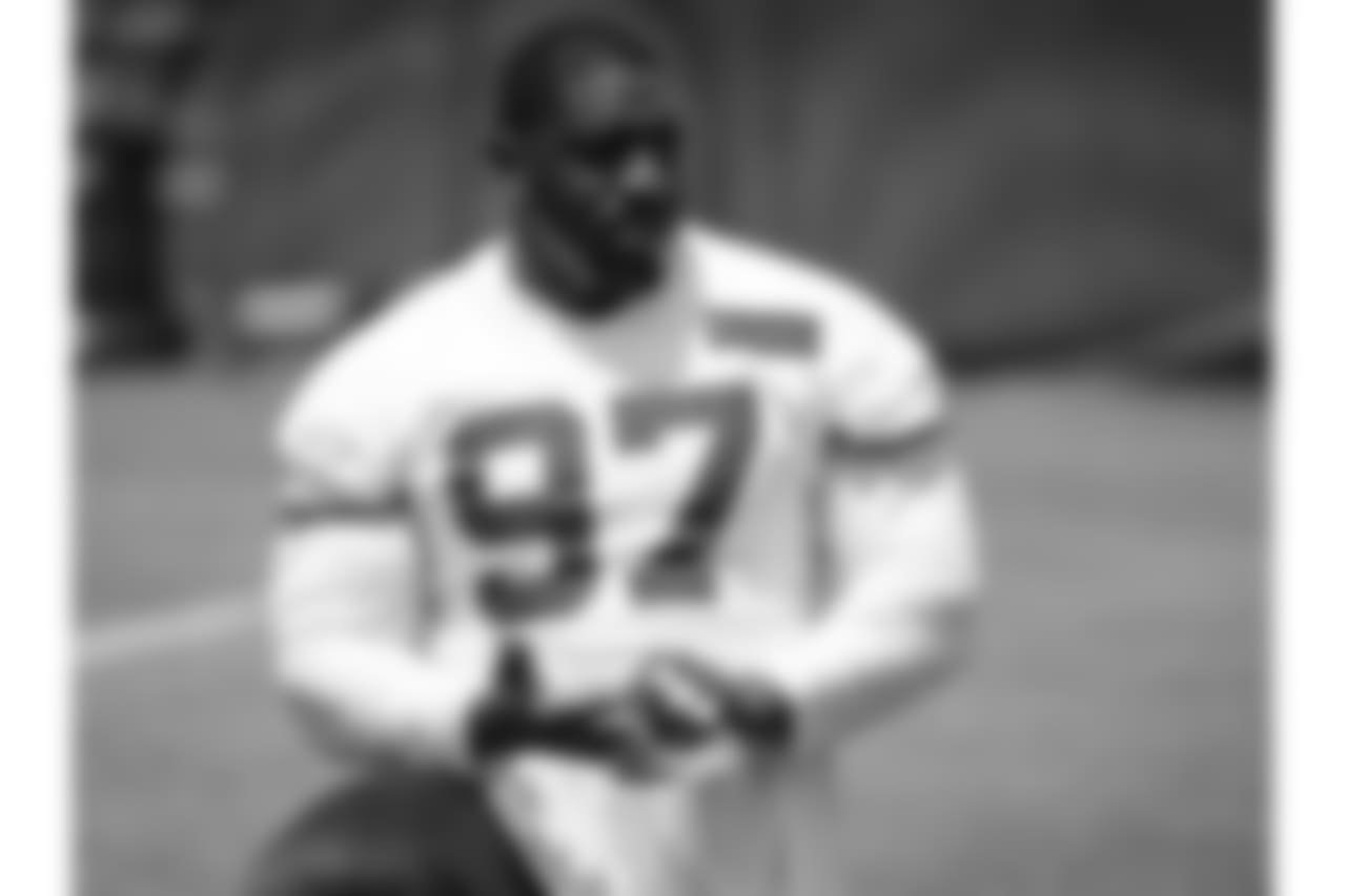 Kansas City Chiefs defensive lineman Allen Bailey (97) removes tape from his fingers at the end of practice on day two of the third week of OTA's