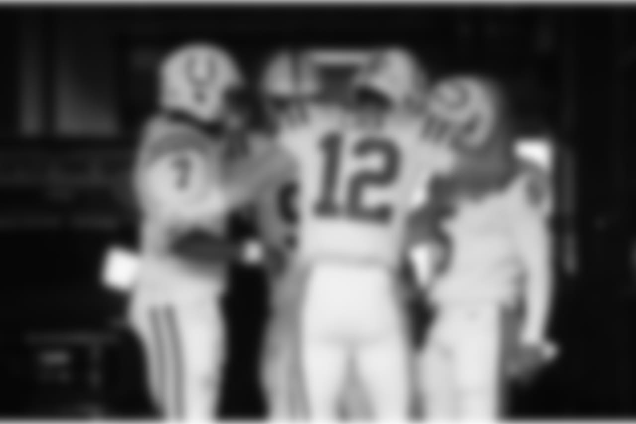 Indianapolis Colts quarterback Andrew Luck (12) hugs quarterback Phillip Walker (5) in the tunnel as he huddles with quarterbacks Jacoby Brissett (7) and Brad Kaaya (9) passes before taking the field for warmups before an NFL football preseason game against the Seattle Seahawks, Thursday, Aug. 9, 2018, in Seattle. (AP Photo/Stephen Brashear)