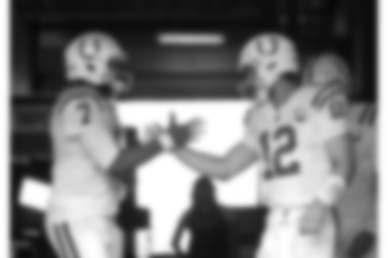 Indianapolis Colts quarterback Andrew Luck (12) greets backup quarterback Jacoby Brissett (7) before taking the field for warmups before an NFL football preseason game against the Seattle Seahawks, Thursday, Aug. 9, 2018, in Seattle. (AP Photo/Stephen Brashear)