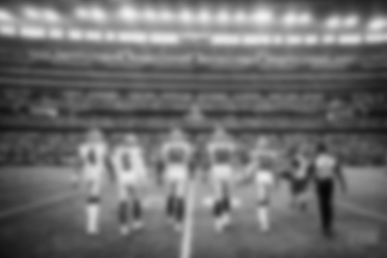 The Dallas Cowboys team captains walk to the middle of the field for the coin toss prior to an NFL football game against the Green Bay Packers, Sunday, Oct. 8, 2017, in Arlington, Texas. The Packers defeated the Cowboys, 35-31. (Ryan Kang via AP)