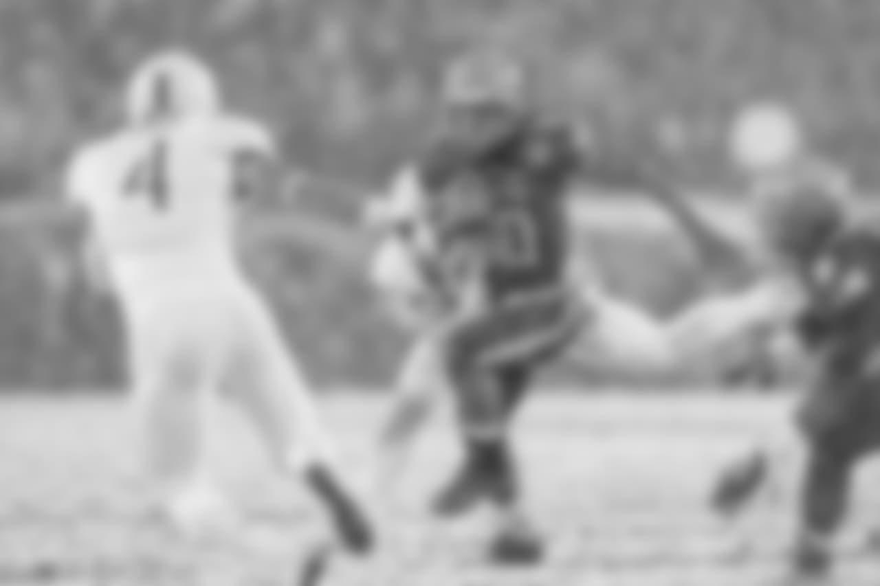 Navy QB Malcolm Perry runs with the ball, as Army DB Max Regan looks to make the tackle.