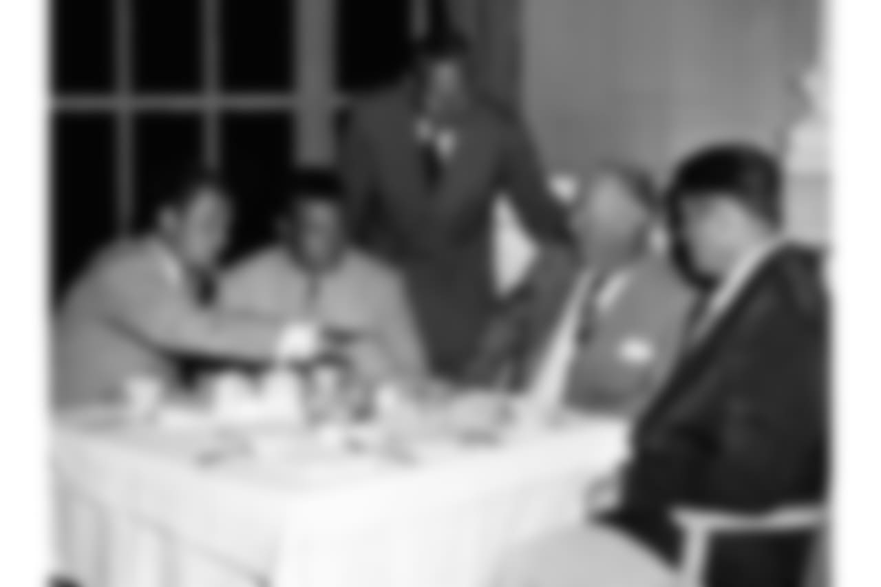 Al Wistert, standing, with QB Tommy Thompson, RB Steve Van Buren, Coach Greasy Neale and C Alex Wojciechowicz meet in Chicago in 1949 ahead of an exhibition game