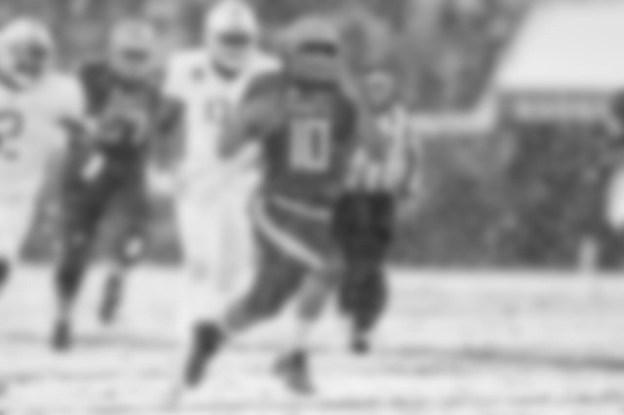 Navy QB Malcolm Perry runs through the Army defense.