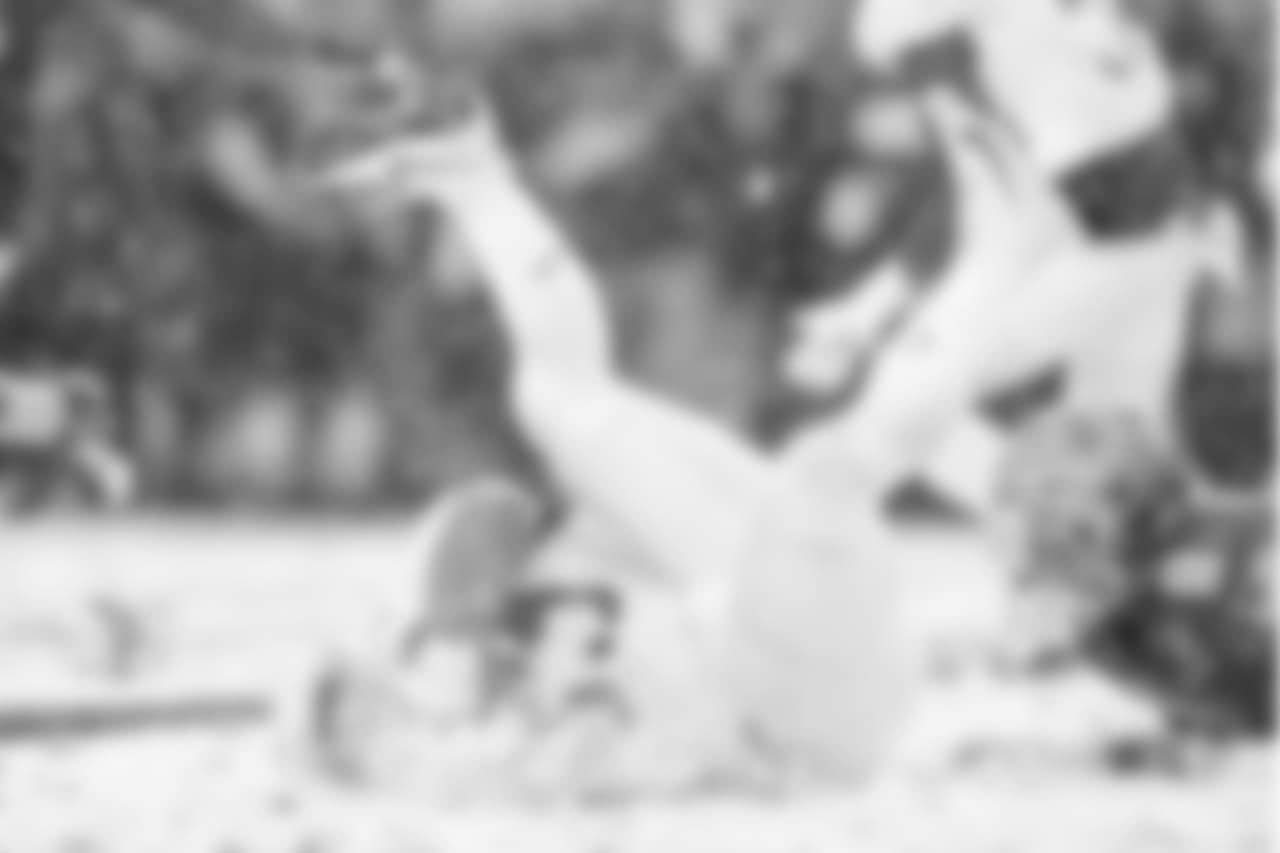 Army RB Darnell Woolfolk falls into a pile of snow.