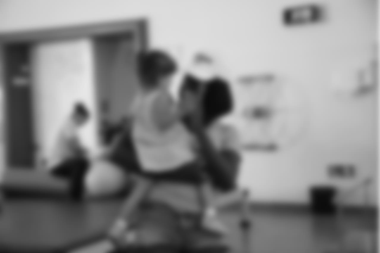 Kayla applauds a young girl after her physical therapy session