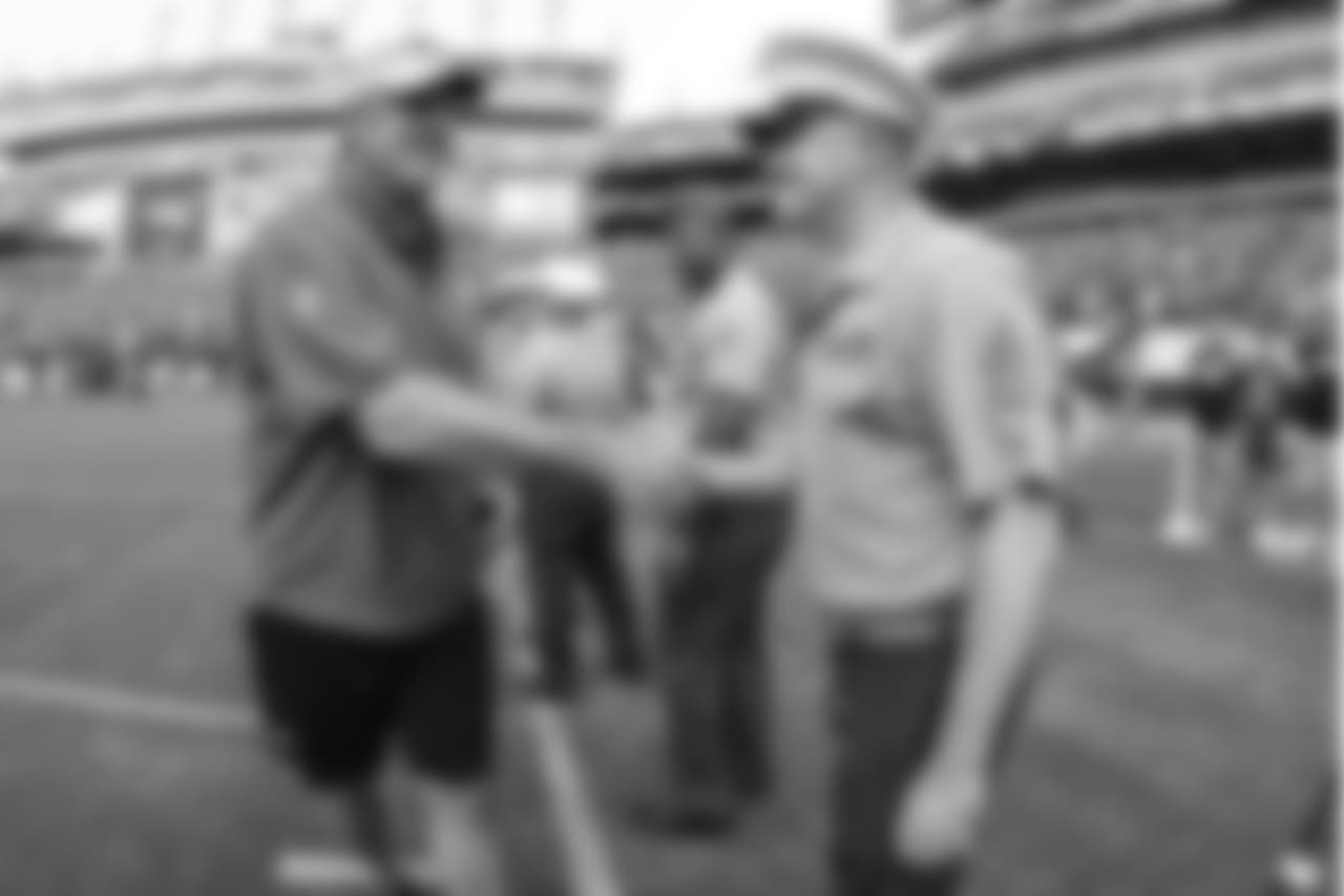 Head coach Doug Pederson greets military members