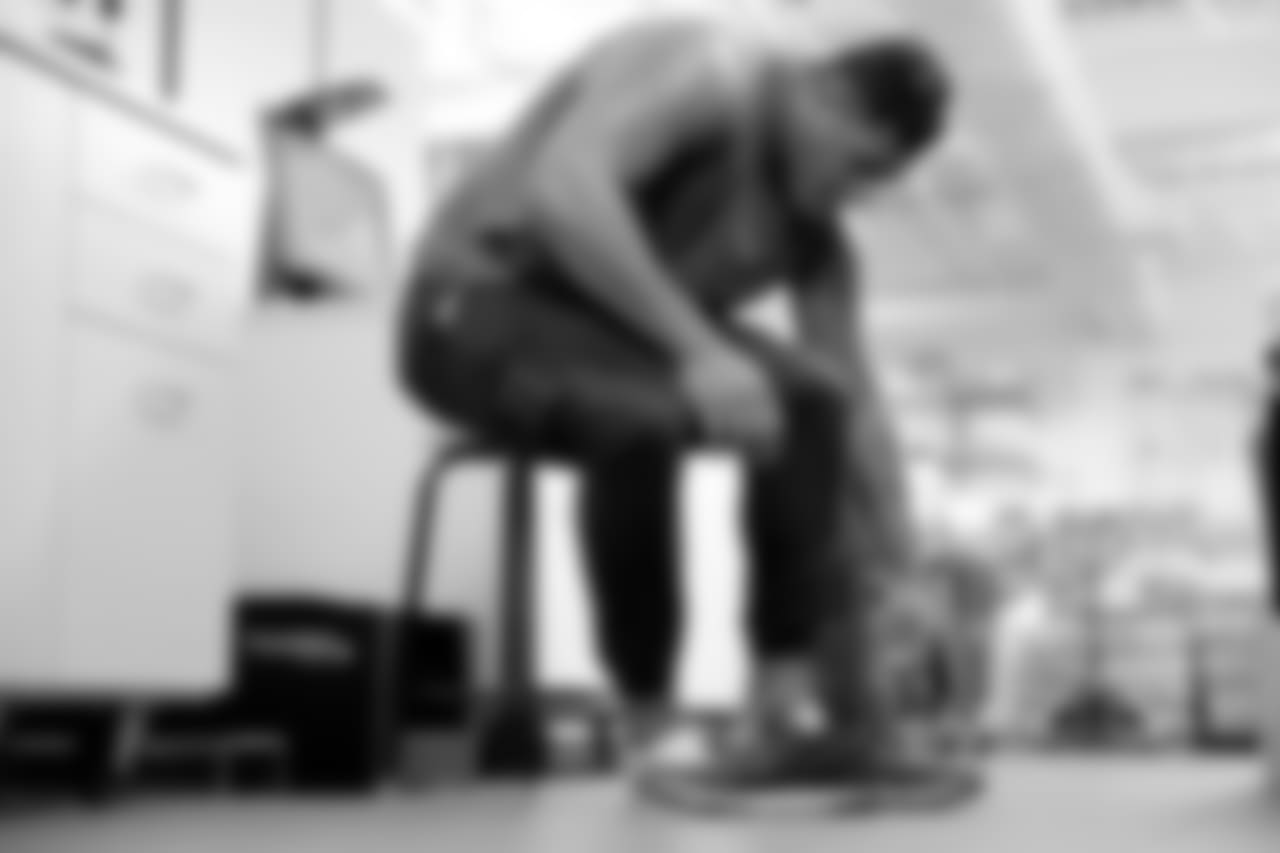 Mailata takes off his shoes so he can try on a pair of size 18 cleats.