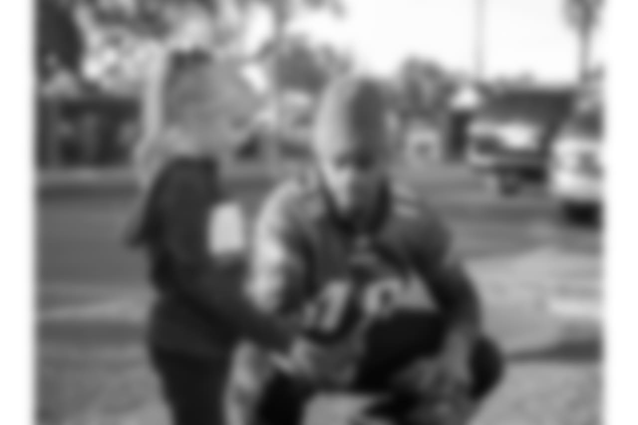 WR Shelton Gibson chats with a child.