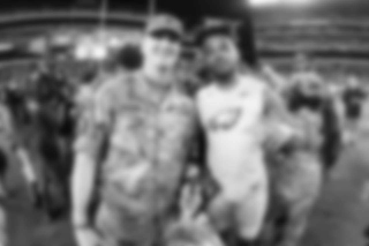 WR Bryce Treggs poses for a picture with a soldier.
