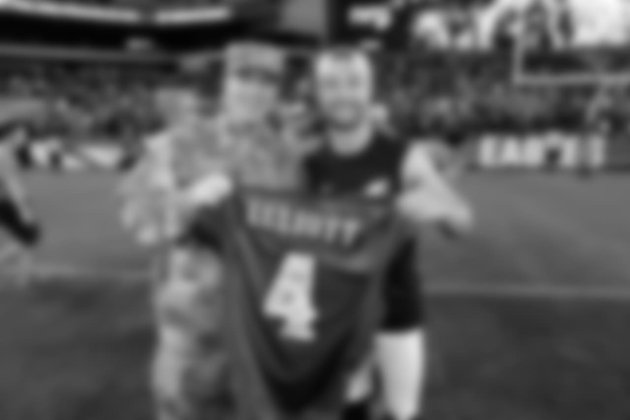 Jake Elliott with a member of the military during Military Appreciation Night