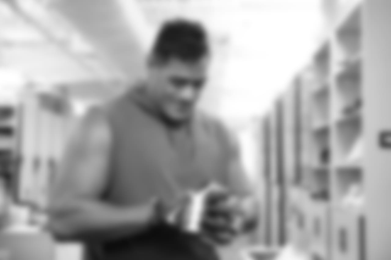 Mailata tries on a pair of gloves in the equipment room.