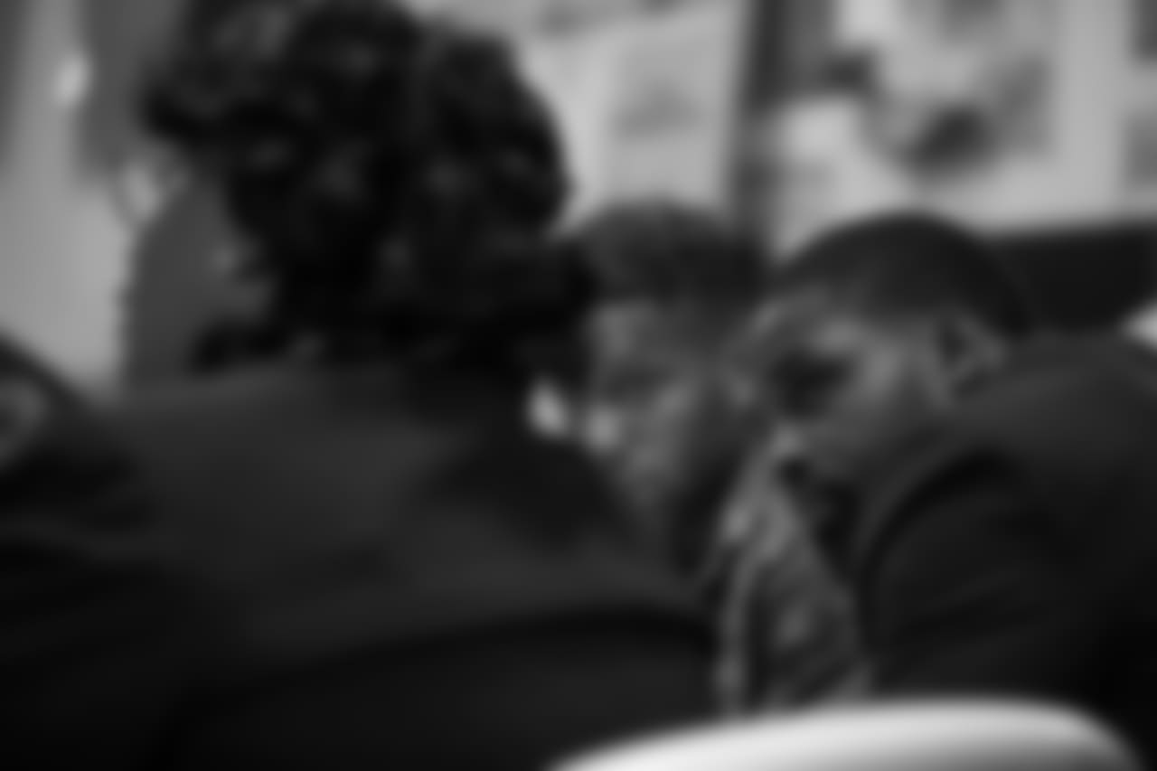 Torrey Smith listens to Reverend Michelle Simmons, founder and CEO of Why Not Prosper.